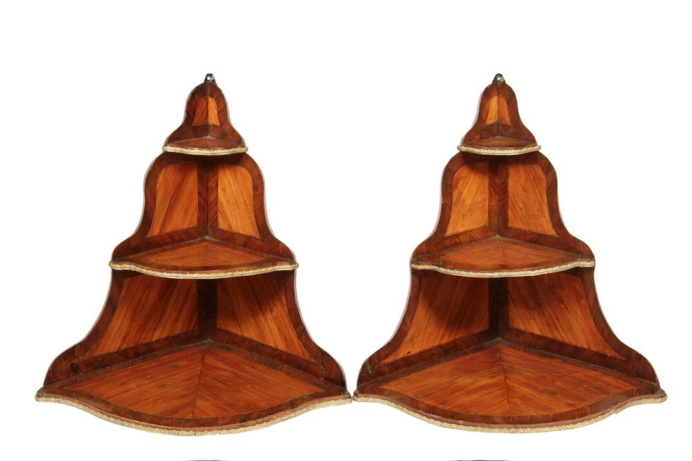PAIR OF CONTINENTAL HANGING SHELVES - Continental: PAIR OF CONTINENTAL HANGING SHELVES - Continental Fruitwood Corner Shelves, having three graduated levels with conforming shaped side panels, banded, string inlaid and with ormolu edging. 24" x 19" x