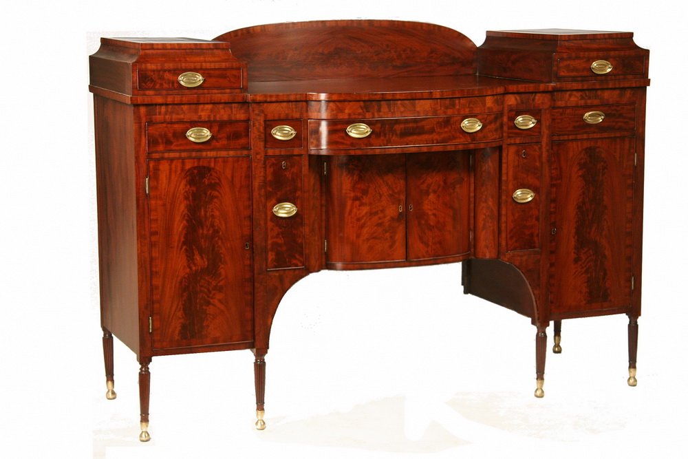 SHERATON SIDEBOARD - New York Sheraton Figured Mahogany: SHERATON SIDEBOARD - New York Sheraton Figured Mahogany Shaped Front Sideboard, attributed to Duncan Phyfe, NYC, first quarter 19th c, raised backsplash with two deck drawers, five drawers beneath and