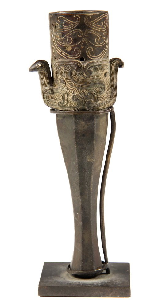 ANCIENT CHINESE BRONZE MOUNT - Warring States 'Zhun' or: ANCIENT CHINESE BRONZE MOUNT - Warring States 'Zhun' or Pole Arm Foot, ca 400 BC, with engraved decoration at egg-shaped throat, dimensional bird below. Drilled for pin mount. 5" long. Includes stand.
