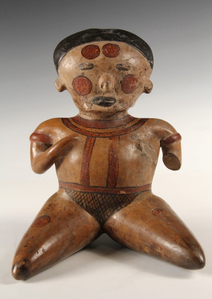 PRE-COLUMBIAN CLAY SCULPTURE - Mayan Huastec Seated: PRE-COLUMBIAN CLAY SCULPTURE - Mayan Huastec Seated Funerary Figure in polished earthenware, with skin tone slip, red and black detailing of clothing and tattoos, presented with legs spread. 10" tall