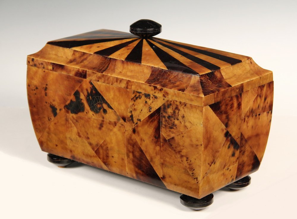 TORTOISESHELL BOX - Casket Form Desk Box with radiating: TORTOISESHELL BOX - Casket Form Desk Box with radiating contrasting inlay on domed top, central knop, incurved sides, set on supressed ball feet. Velvet lining. Fine quality. ca 1970s. 9" x 12" x 6". 