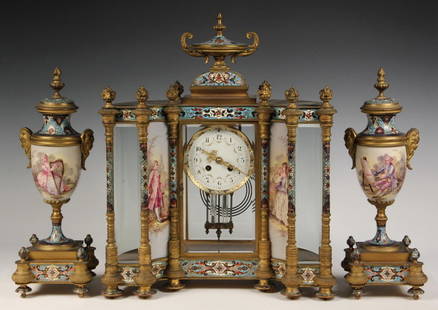 MAGNIFICENT FRENCH MANTEL CLOCK WITH GARNITURES - Hour: MAGNIFICENT FRENCH MANTEL CLOCK WITH GARNITURES - Hour 8-Day Time and Strike, circa 1890, in gilt bronze and crystal with cloisonne decoration. The concave architectural form of the clock is surmounte