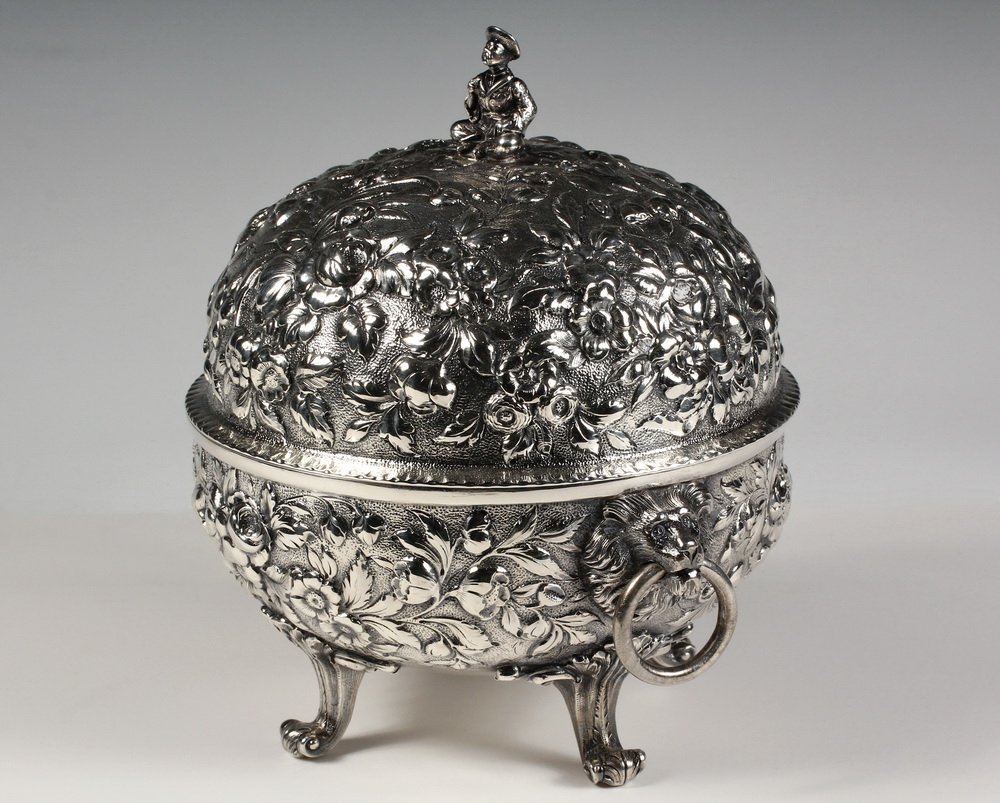 S. KIRK & SON BALTIMORE STERLING SILVER COVERED BOWL -: S. KIRK & SON BALTIMORE STERLING SILVER COVERED BOWL - In repousse pattern, with lion head drop ring handles and four scrolled feet, having 1868-1896 version of company mark, stamped "11 OZ", or .9166