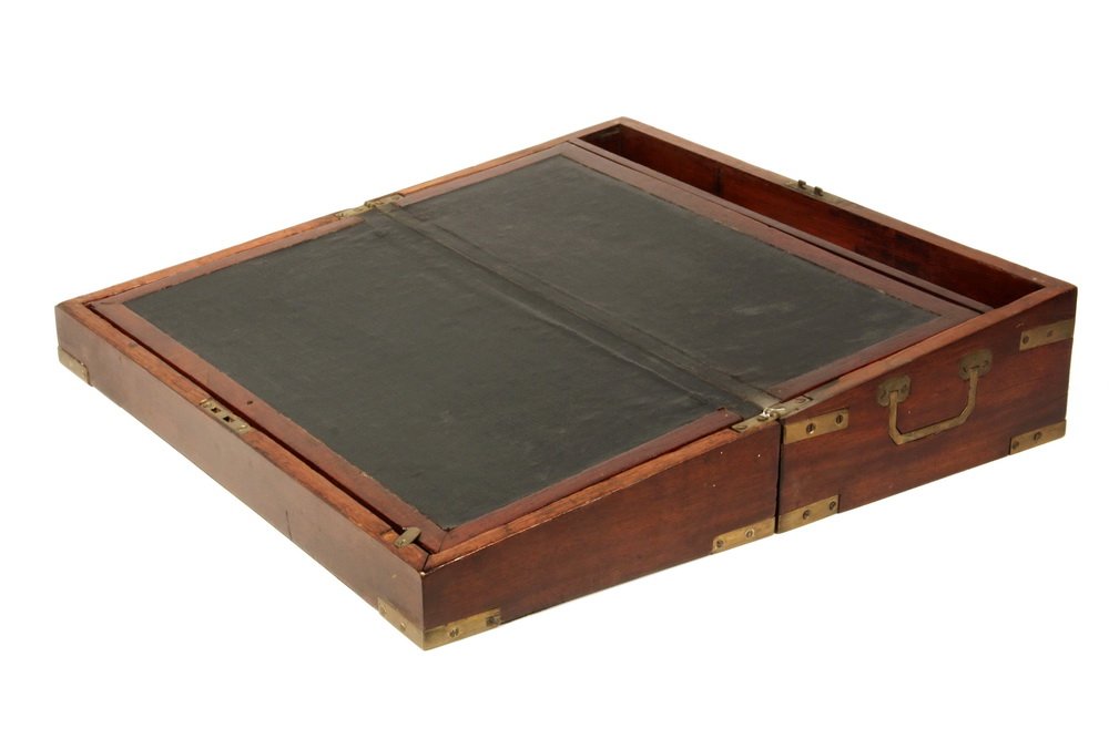 TRAVELING DESK - Brass Bound Mahogany Case, with top: TRAVELING DESK - Brass Bound Mahogany Case, with top plate engraved "Dr. J. Bartlett, Jr, 1819". Green oilcloth slanted writing surface with compartments beneath, flush mounted brass handles, working 