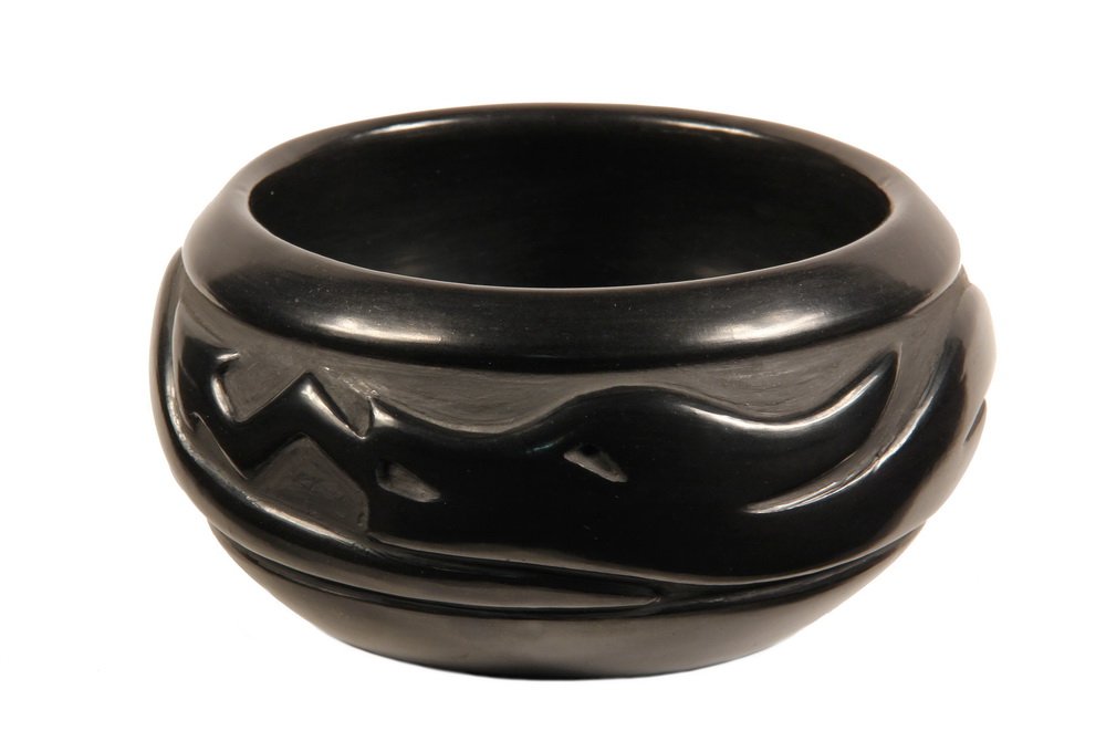 NATIVE AMERICAN POTTERY - Mary Singer, Santa Clara: NATIVE AMERICAN POTTERY - Mary Singer, Santa Clara Pueblo, New Mexico, black on black, boldly carved with the Avanyu water serpent, inscribed by artist under base. 3 1/2" x 7 1/4" diam. Fine condition