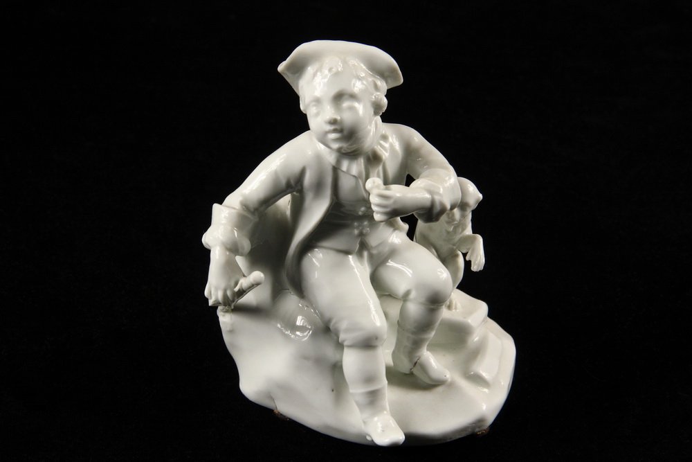 EARLY DRESDEN FIGURINE - Blanc de Chine of a Little Boy: EARLY DRESDEN FIGURINE - Blanc de Chine of a Little Boy Traveler with Monkey, both seated on a rock outcropping, he is holding a staff and fruit, his pet has a paw raised. Early blue beehive mark. 4 3