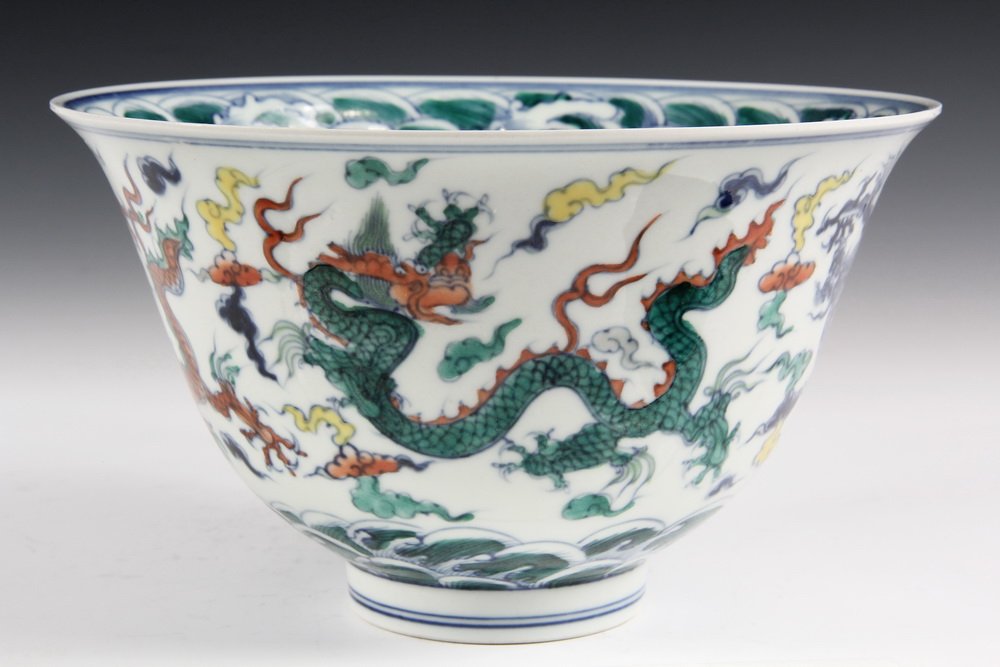 CHINESE PORCELAIN - Large Deep Wucai Bowl decorated: CHINESE PORCELAIN - Large Deep Wucai Bowl decorated with dragons and having Ming mark, (possibly Kangxhi). In box. 4 7/8" x 8 1/4" diam. One tiny rim glaze inclusion.