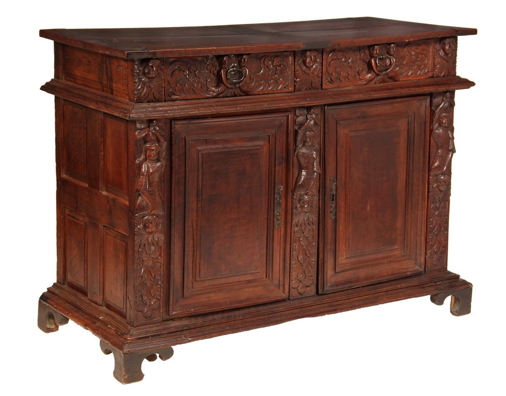 WALNUT CREDENZA - 18th c. English Black Walnut Server: WALNUT CREDENZA - 18th c. English Black Walnut Server with overhanging wood pegged plank top, two leaf carved drawers with pairs of figures flanking iron ring pulls, three cherub heads above three sta