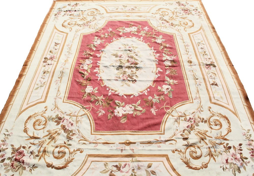 AUBUSSON CARPET - 11'9" x 14'9" - France, Oval floral: AUBUSSON CARPET - 11'9" x 14'9" - France, Oval floral medallion with a rose pink frame set on a pale blue field, floral and leaf designs in pink, ivory, tan, olive and light blue. Good condition.