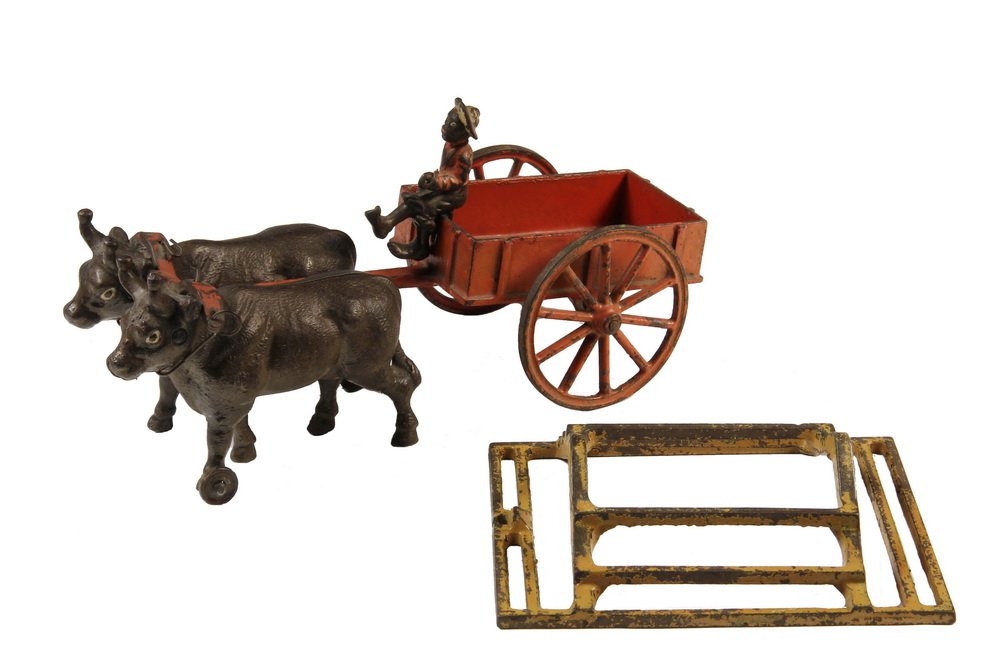CAST IRON PULL TOY - Oxen Drawn Hay Wagon with: CAST IRON PULL TOY - Oxen Drawn Hay Wagon with removable rack and African-American rider, unmarked, possibly Hubley, 6 1/2" x 12" x 5", good condition, 70% paint.