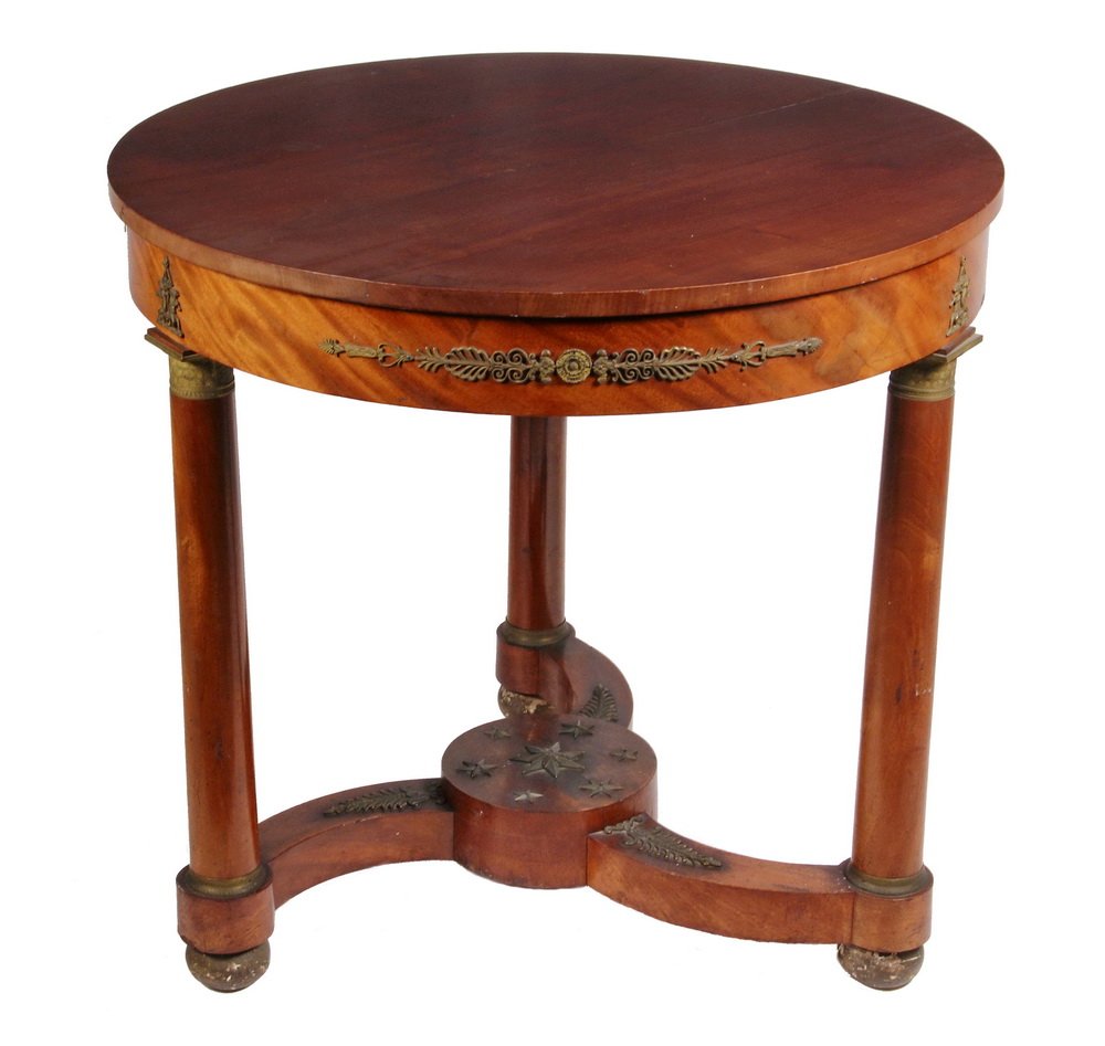 EMPIRE CENTER TABLE - Period French Empire Round: EMPIRE CENTER TABLE - Period French Empire Round Mahogany Center Table, overhanging top, ormolu mounts, three column form legs, curved leaf mounted stretchers, center star mounted disc. 28 1/2" x 30 3
