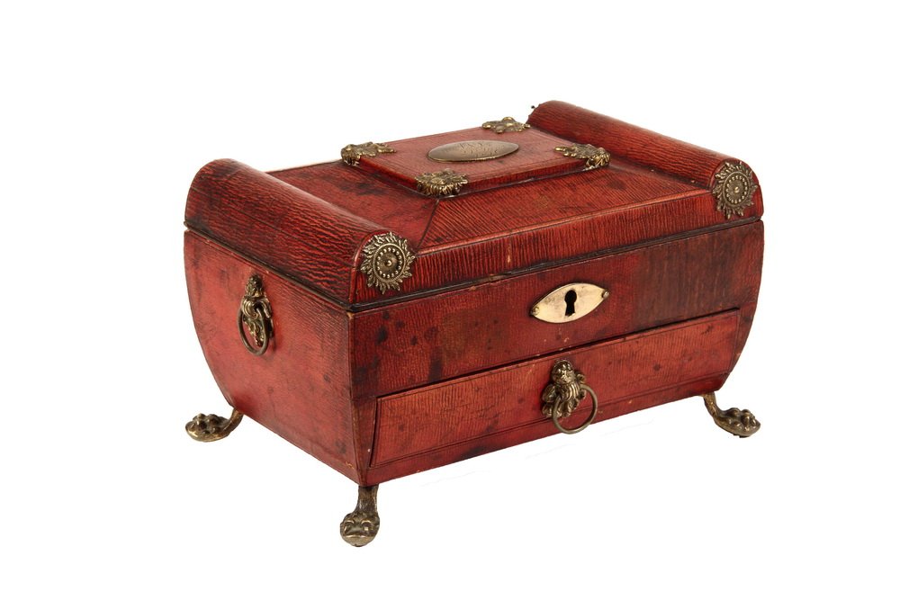 ENGLISH SEWING BOX - Regency Period, Casket Form, in: ENGLISH SEWING BOX - Regency Period, Casket Form, in embossed red leather with gilt brass fittings and lion paw feet, ring handles, having silver placket on top engraved "MS, Jany. 21, 1816". The inte
