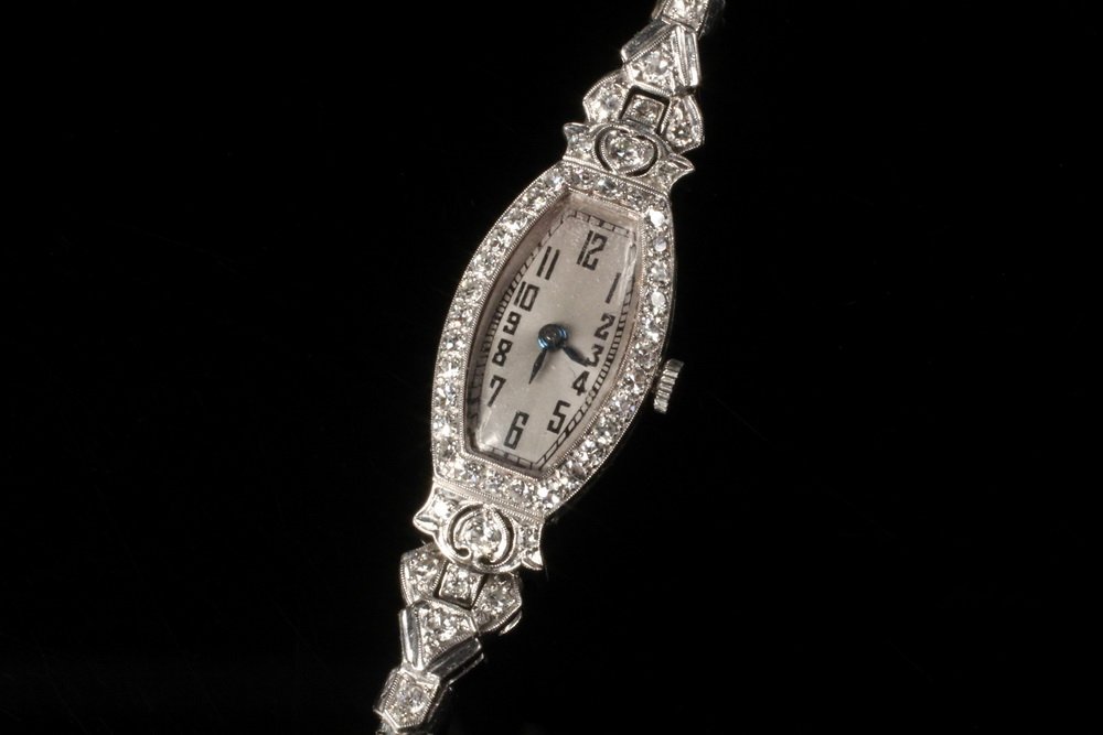 LADY'S WRISTWATCH - Edwardian Platinum and Diamond: LADY'S WRISTWATCH - Edwardian Platinum and Diamond Dress Wristwatch, ca. 1910, with replaced quartz movement and 14K white gold snakeskin band. 3/4" wide, 7" long. Fine condition.