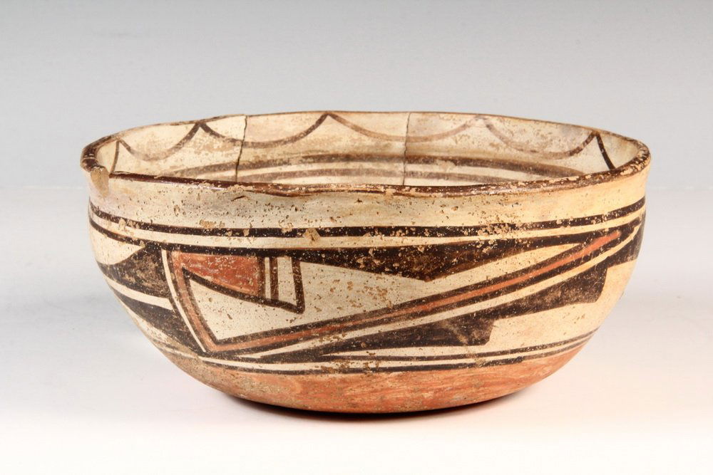 NATIVE AMERICAN POTTERY BOWL - Early Anasazi decorated: NATIVE AMERICAN POTTERY BOWL - Early Anasazi decorated redware bowl, reassembled, 3 1/2" x 8 1/4" diam, one piece missing, chipped rim, paint loss.