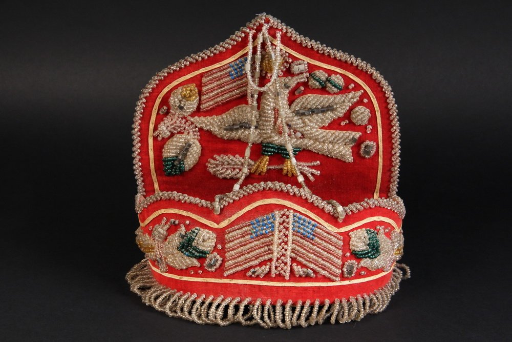 IROQUOIS BEADWORK - Centennial Era Wall Pocket in red: IROQUOIS BEADWORK - Centennial Era Wall Pocket in red wool with beadwork of American Flags and Eagle, swags and loop fringe, 9" x 9" x 3", good condition.
