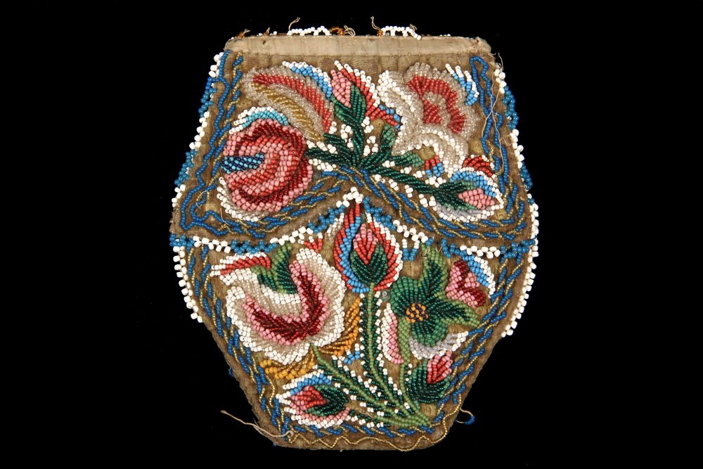 IROQUOIS BEADED POUCH - 19th c Six-Sided and Double: IROQUOIS BEADED POUCH - 19th c Six-Sided and Double Flapped Bag with polychrome floral beadwork on both sides, over brown velvet, silk binding, polished cotton lining, 6" x 5", losses to bead edging.