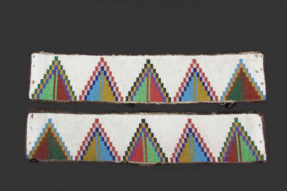 PAIR OF NATIVE AMERICAN BEADED PANELS - Yankton Sioux,: PAIR OF NATIVE AMERICAN BEADED PANELS - Yankton Sioux, circa 1880, legging strips, in lane stitch, with red, gold, prussian, cobalt and aqua blue and lime and forest green geometric designs on a white
