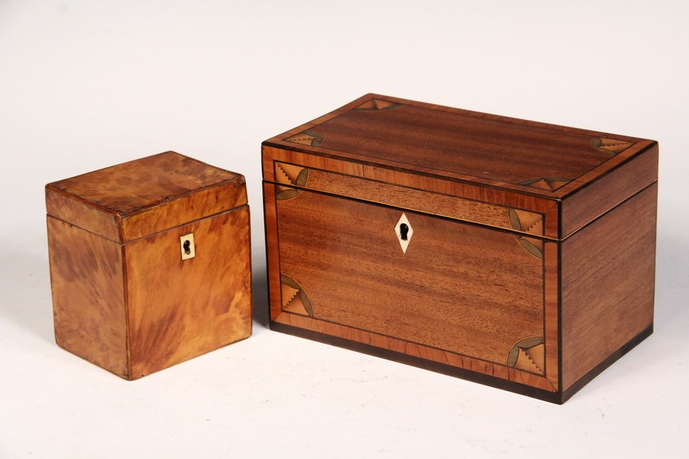(2) ENGLISH TEA CADDIES - Georgian Boxes, circa: (2) ENGLISH TEA CADDIES - Georgian Boxes, circa 1780-1800, both without partititon, the larger in Mahogany with cross-banded edge, ebony stringing, shell brackets, ivory diamond lock escutcheon with o