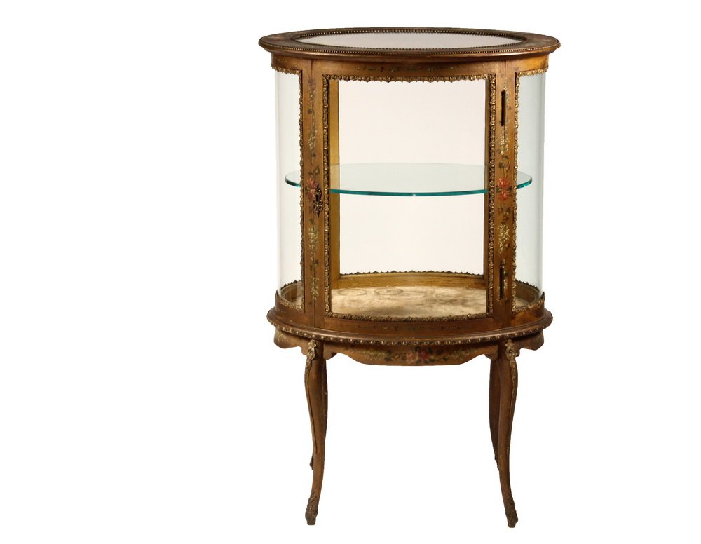 OVAL FRENCH VITRINE - Gold Finished Two Shelf Oval: OVAL FRENCH VITRINE - Gold Finished Two Shelf Oval Vitrine, circa 1900, with overall polychrome floral detailing, ormolu beaded overhanging molded top having mitered top glass, locking door with key, 