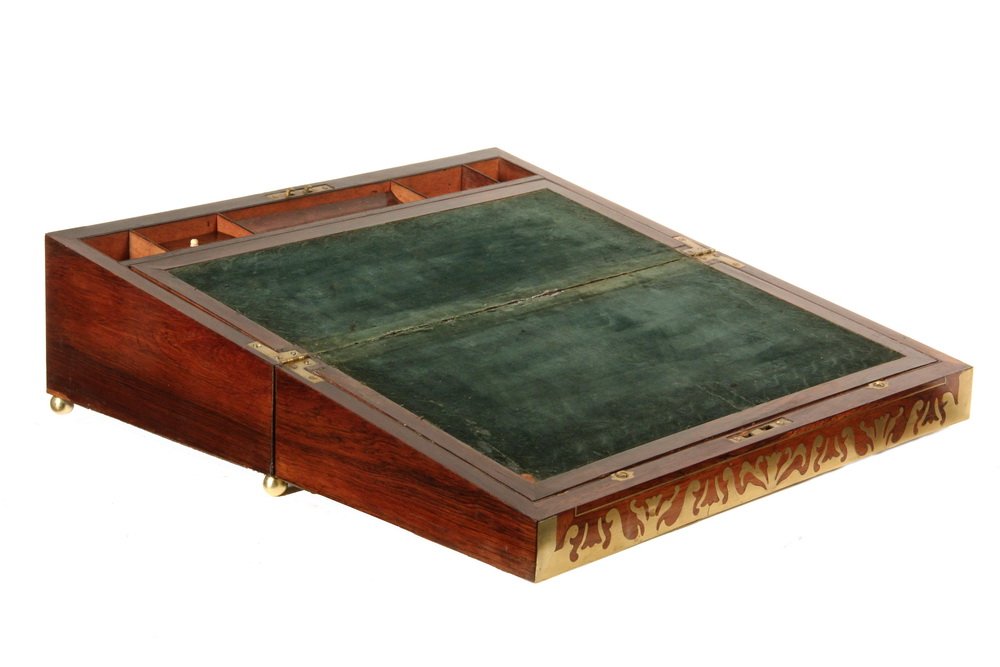 ENGLISH TRAVEL DESK - Rosewood Box with ornately shaped: ENGLISH TRAVEL DESK - Rosewood Box with ornately shaped brass binding, top plate and lock escutcheon, ball feet, the interior fitted with slanted tooled green velvet writing surface, ink bottle, pen c