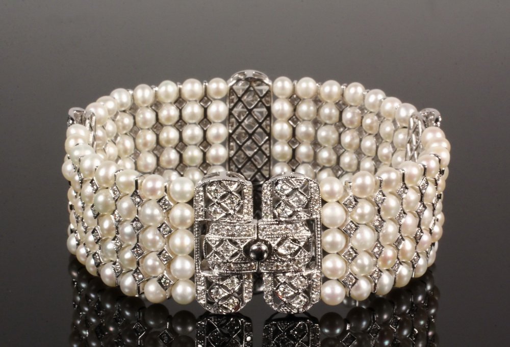 BRACELET - Edwardian Style 18K White Gold, Pearl and: BRACELET - Edwardian Style 18K White Gold, Pearl and Diamond "Five-Row" Bracelet, with (150) pearls. 7" long x 1" wide. Fine condition.