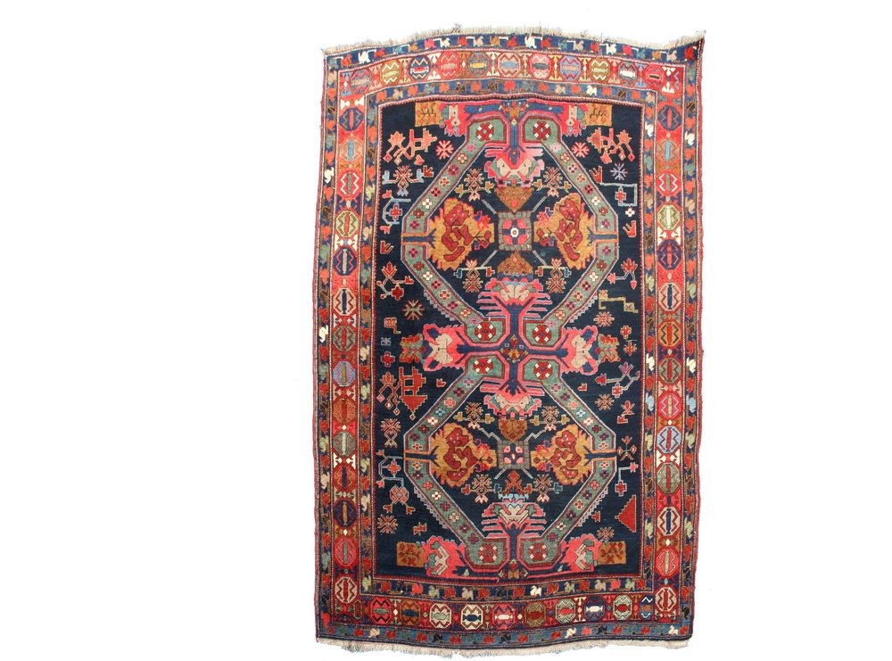 SEICHOUR RUG - 5'10" x 8'5" - Northeast Caucasus, early: SEICHOUR RUG - 5'10" x 8'5" - Northeast Caucasus, early 20th c, midnight blue field with two 'St. Andrew' cross motifs in sky blue, ivory, teal, carmel and red, rust-red geometric border.