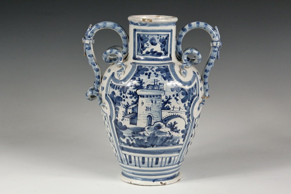 DUTCH FAIENCE POTTERY - Large Delft Vase dated 1716,: DUTCH FAIENCE POTTERY - Large Delft Vase dated 1716, initialed F.D., having two applied double-snake handles, blue decoration of a castle, 12" tall. Loss to part of one handle, flakes.