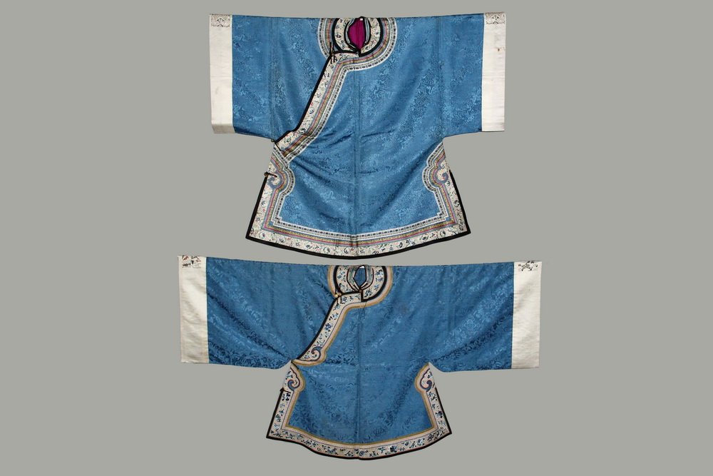 (2) CHINESE ROBES - Similar Man's & Woman's Robes,: (2) CHINESE ROBES - Similar Man's & Woman's Robes, mid-Republic, circa 1920, in sky blue silk damask of the same color but different pattern, having similar white polychrome embroidered figural collar