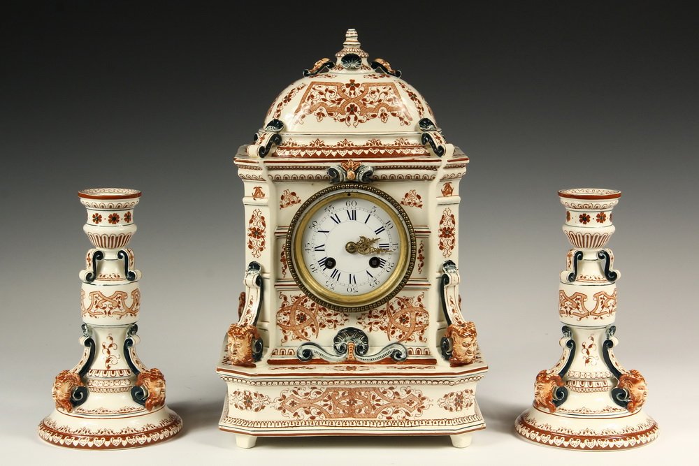 (3 PC) FRENCH PORCELAIN MANTEL SET - Longway Henri II: (3 PC) FRENCH PORCELAIN MANTEL SET - Longwy Henri II Faience Set consisting of Clock and Pair of Candlesticks, in architectural form with brown and blue decoration, having impressed marks for 1887 pro