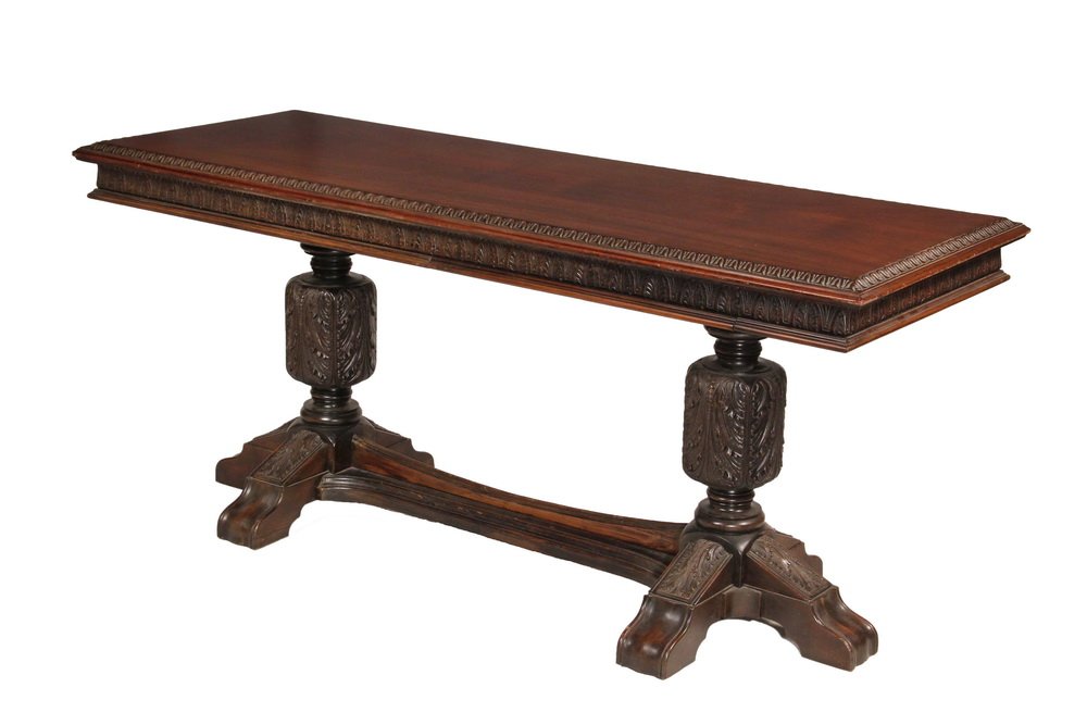 LIBRARY TABLE - 1920s Renaissance Revival Pier Table in: LIBRARY TABLE - 1920s Renaissance Revival Pier Table in mahogany with acanthus leaf edge, leaf carved and molded ogee skirt, opposing concealed single drawers on long sides, two post legs with leaf ca