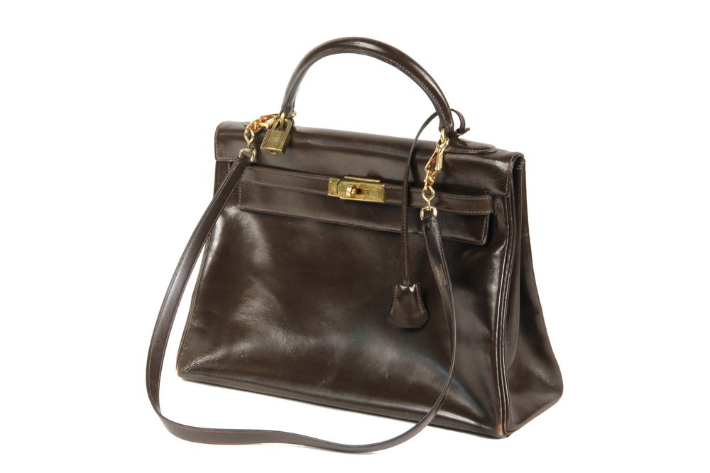 DESIGNER PURSE - Vintage (1972) Hermes Kelly Retourne: DESIGNER PURSE - Vintage (1972) Hermes Kelly Retourne handbag in Havane Veau Box Leather, with strap and lock, 9 1/4" x 12 1/2" x 4 3/4", pre-owned with signs of use. Good condition, strap accompanyin