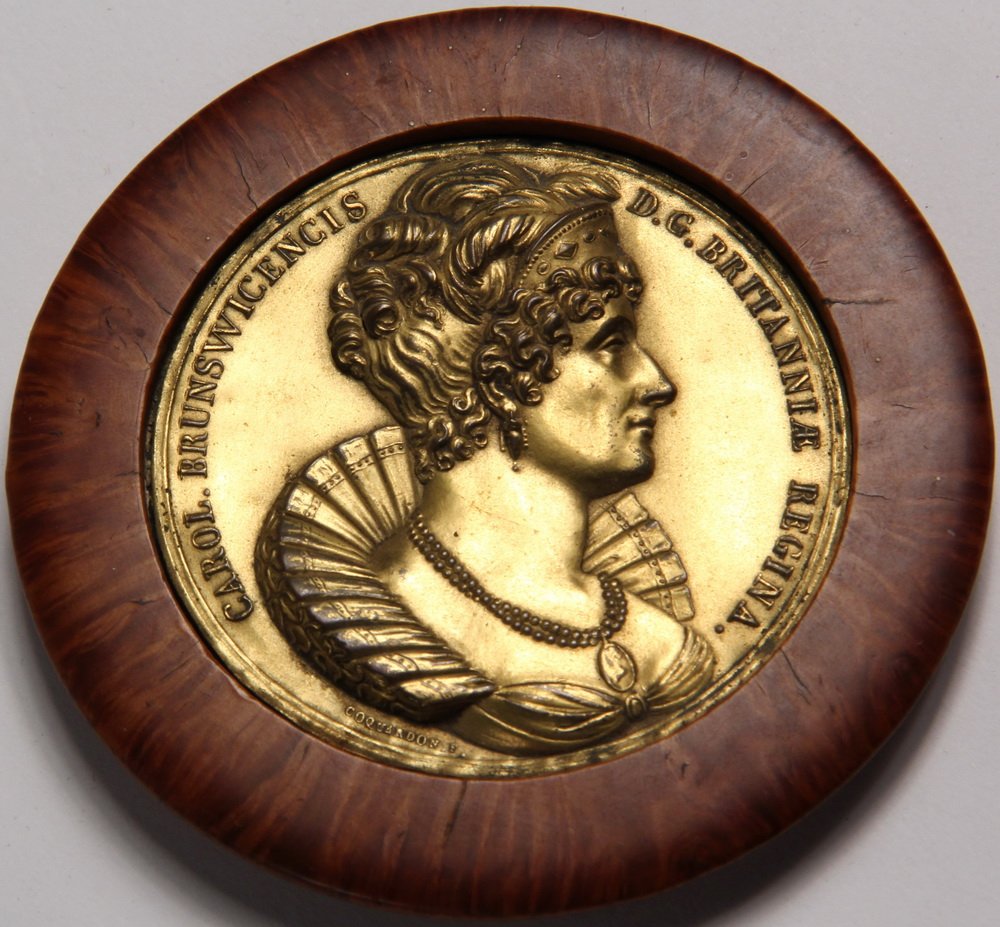 SNUFF BOX LID - Gilt Copper Repousse with Burlwood: SNUFF BOX LID - Gilt Copper Repousse with Burlwood Surround. A profile portrait commemorating the death of Queen Caroline, 1821, by Coquardon. Inscription: CAROL. BRUNSWICENSIS D. G. BRITANNIAE REGINA