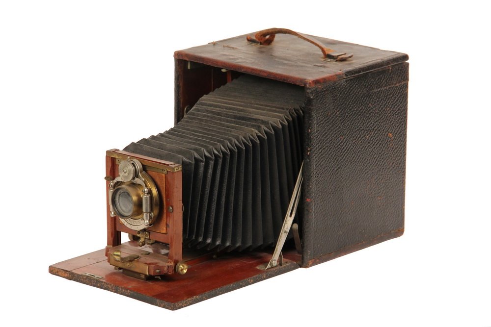 RARE EARLY CAMERA - 1892 Folding Rochester 4x5 Format: RARE EARLY CAMERA - 1892 Folding Rochester 4x5 Format 'Poco' Camera with Unicum shutter, Bausch & Lomb lens, having leather covering inside and out, mahogany and brass fixtures, intact leather bellows