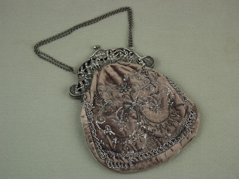 LADY'S EVENING PURSE - Circa 1880-90, reticulated: LADY'S EVENING PURSE - Circa 1880-90, reticulated unmarked German silver frame with chain, velvet bag with floral design in steel beads and sequins, silk lined interior with small mirror, 10" x 7 1/2"