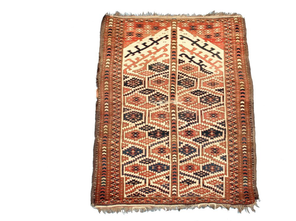 TURKOMAN PRAYER RUG - 3 1/2' x 4'9" - West Turkoman,: TURKOMAN PRAYER RUG - 3 1/2' x 4'9" - West Turkoman, late 19th c, staggered rows of polygon motifs in navy blue and rust, set on an ivory field, rust diamond border, rare design. Crease and wear to ce