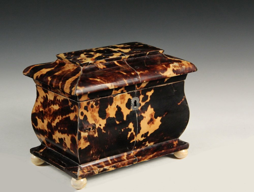 TEA CADDY - English Dark Tortoiseshell Bombe Shaped: TEA CADDY - English Dark Tortoiseshell Bombe Shaped Caddy with stepped and molded overhanging top, having a silver centerline, lock escutcheon, hinges and knops on the two interior covers, with key an