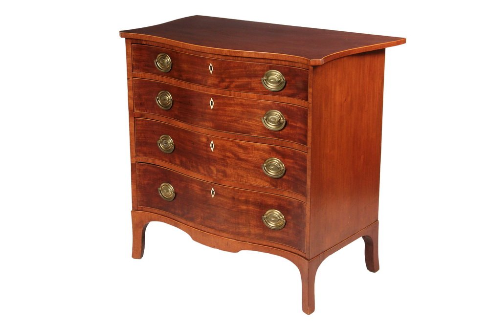 SERPENTINE FRONT DRESSER - Hepplewhite Dresser in: SERPENTINE FRONT DRESSER - Hepplewhite Dresser in mahogany having boxwood edged top, oak secondary conforming front and shaped sides, squared turret corners, four graduated drawers, oval brass pulls, 