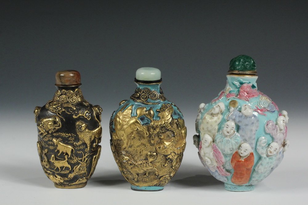 A GROUP OF (3) MOLDED PORCELAIN SNUFF BOTTLES -: A GROUP OF (3) MOLDED PORCELAIN SNUFF BOTTLES - Including: An Imitating Bronze, Black Ground and Gold Enamel Porcelain "Twelve Zodiac Animal" Snuff Bottle with agate cap, 19th c., 3 1/8"; PLUS An Imot