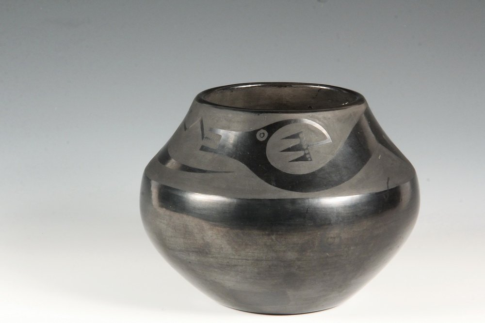 NATIVE AMERICAN POTTERY - San Ildefonso Black on Black: NATIVE AMERICAN POTTERY - San Ildefonso Black on Black Pot, signed Maria & Julian, with a serpent band around the top of the squat olla form. 5 1/2" x 6 1/2" diam. Minor spotting. Maria Montoya Martin