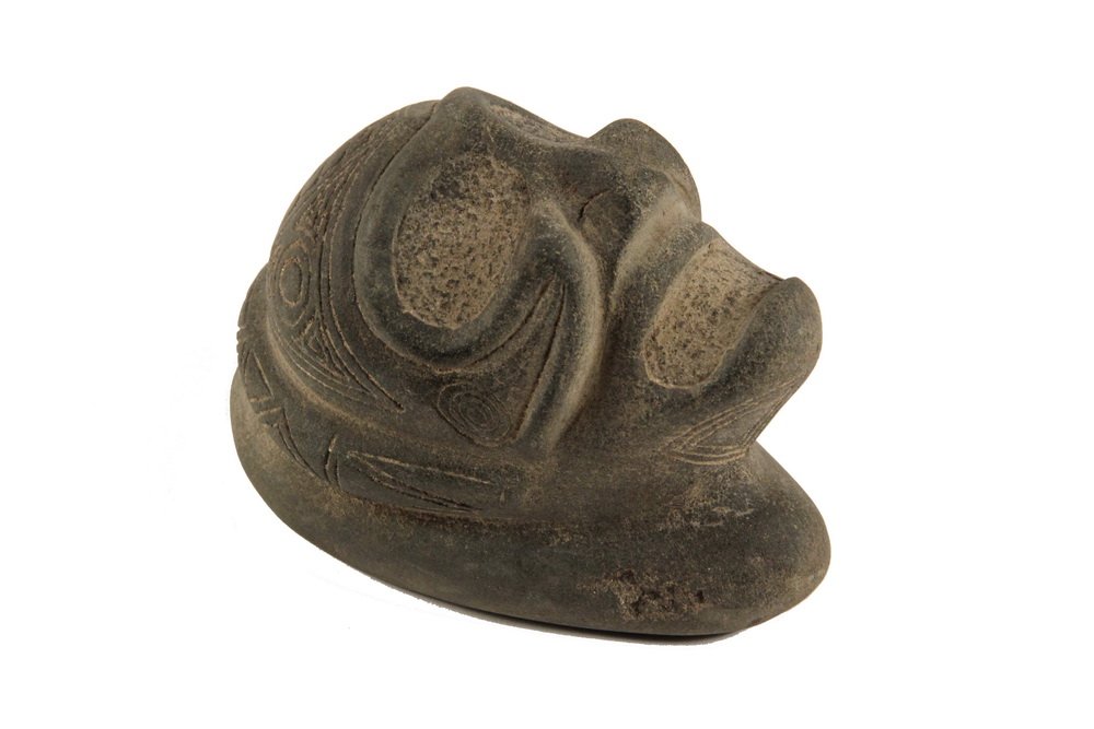 PRE-COLUMBIAN STONE ARTIFACT - Taino People, Classic: PRE-COLUMBIAN STONE ARTIFACT - Taino People, Classic Period (c. 1000-1500 AD), Dominican Republic. Ancestral Head in carved andesite, a skull form profusely engraved with symbolic icons. 5 1/2" long. 