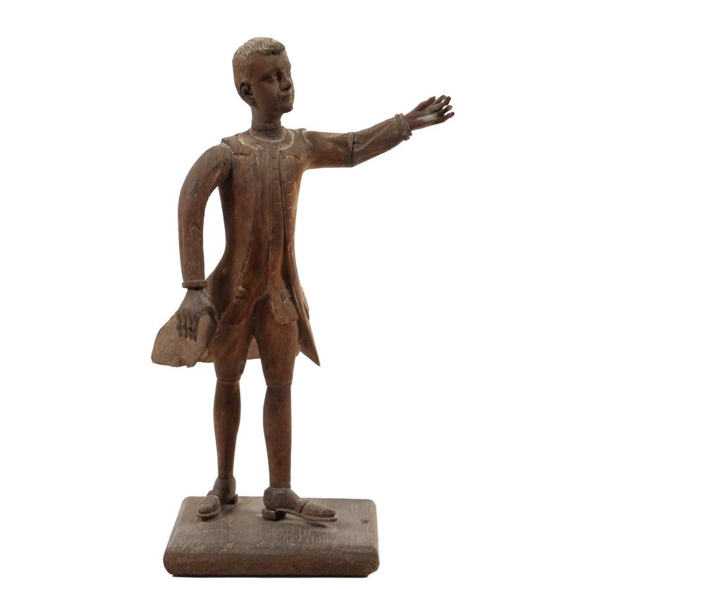 AMERICAN FOLK ART CARVING - 18th c. New England: AMERICAN FOLK ART CARVING - 18th c. New England Colonial Full Length Portrait of a Young Man Giving a Public Speech, in mahogany with elm plate base, his well rendered head set on a slightly cruder bo
