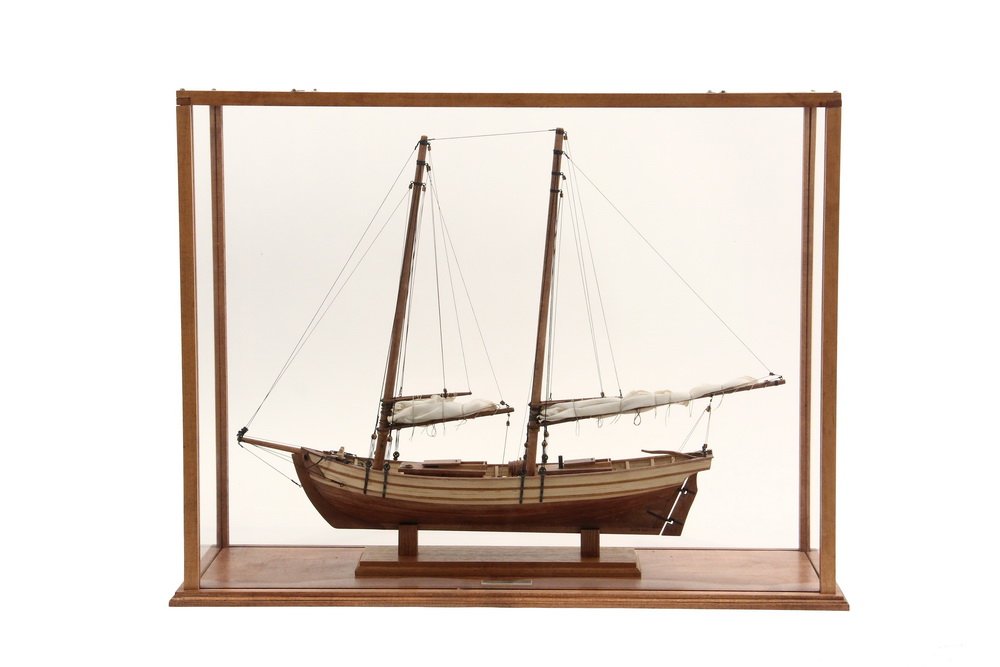 CASED SHIP MODEL - "Schooner 'Paulie', ca. 1900", by: CASED SHIP MODEL - "Schooner 'Paulie', ca. 1900", by Harry McCreery, unmarked. In mahogany and plexiglas case. 18" x 23" x 7 1/4". Fine condition.