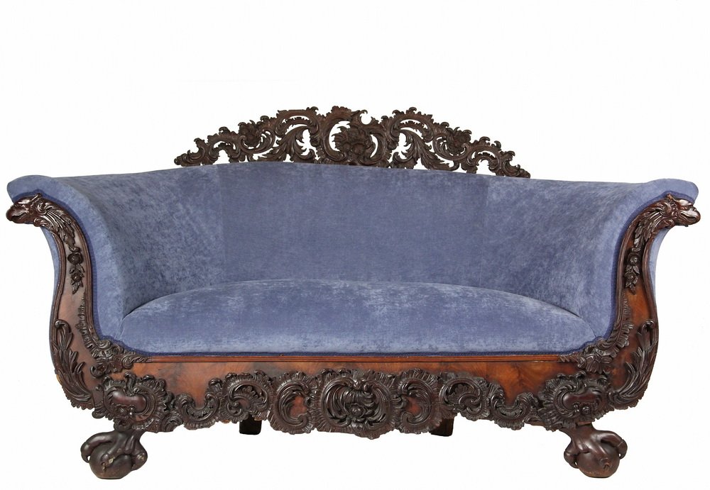 EARLY TRANSITIONAL VICTORIAN SOFA - American, circa: EARLY TRANSITIONAL VICTORIAN SOFA - American, circa 1840, heavily carved black walnut, with rolled barrel back and continuous arm, ornate carved and reticulted leaf scrollwork back crest, eagle head a