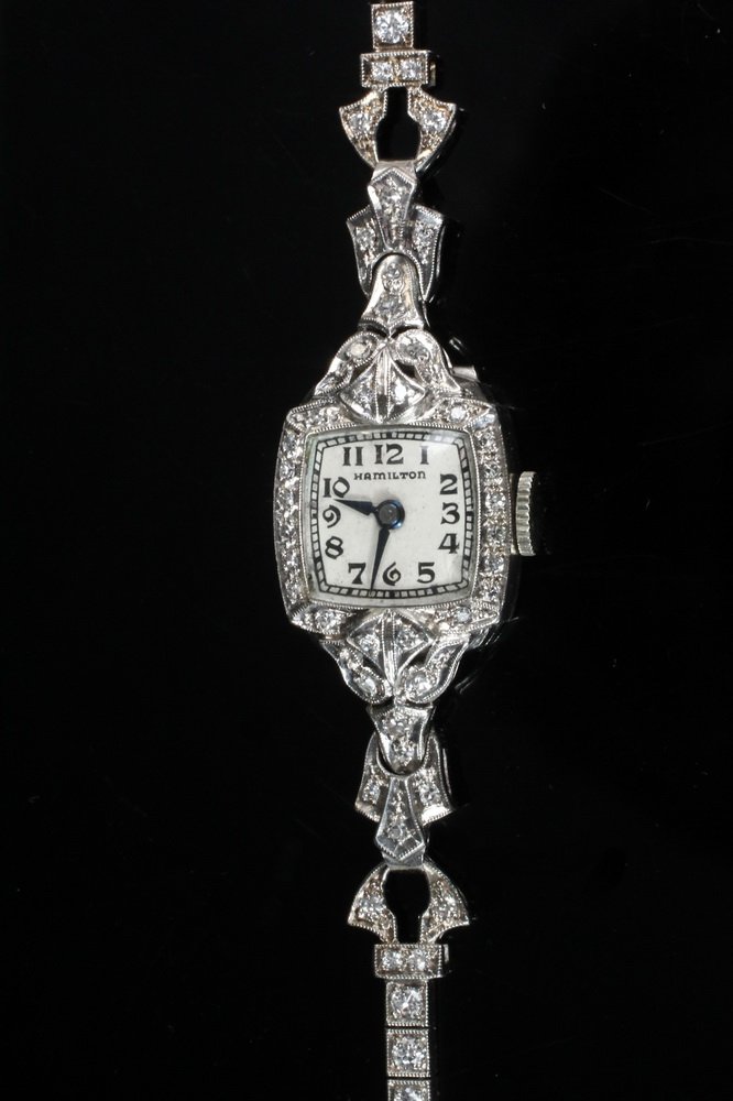 WRISTWATCH - Vintage Platinum and Diamond Set Ladies: WRISTWATCH - Vintage Platinum and Diamond Set Ladies Wristwatch with 17 jewel Hamilton movement; Model 911; Serial No. T10-760; having approximately (80) small diamonds set in bracelet form band and 1