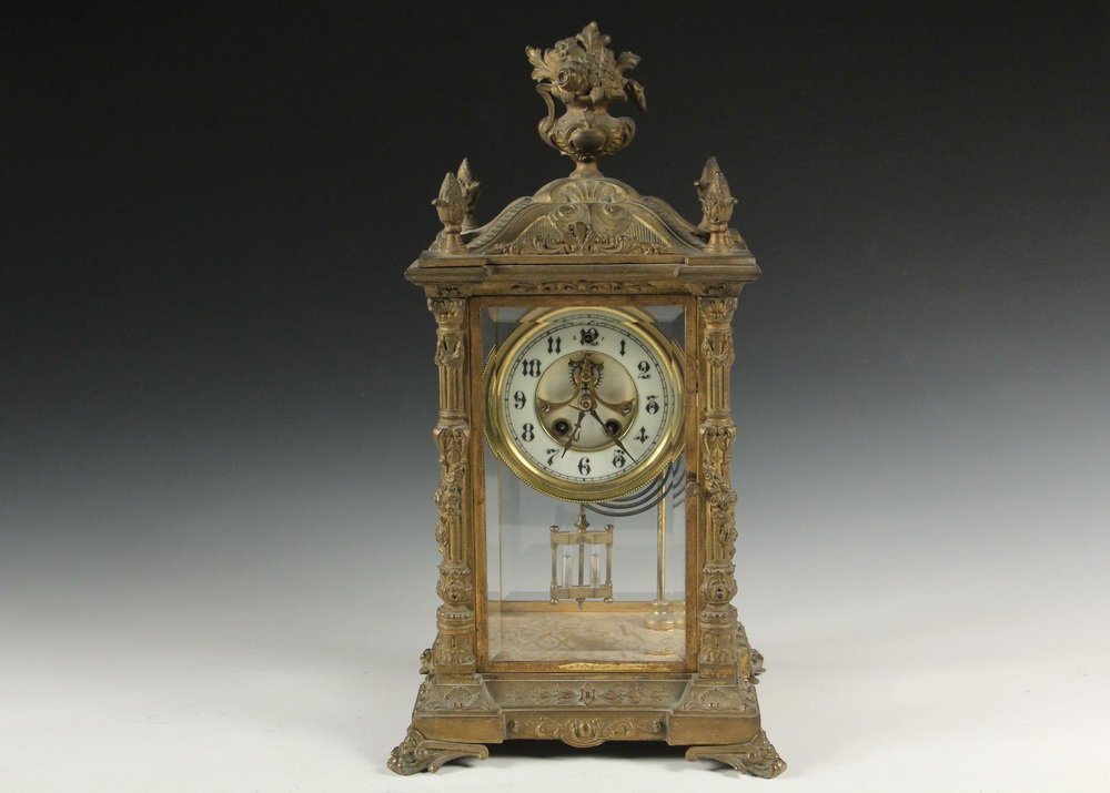 CRYSTAL REGULATOR MANTEL CLOCK - Neo-Classical Gilt: CRYSTAL REGULATOR MANTEL CLOCK - Neo-Classical Gilt Brass Cased 8-DayTime and Strike Clock with stepped porcelain dial with exposed escapement, with the original key and faux mercury bob, beveled glas