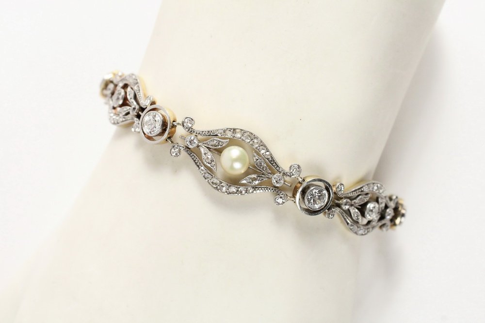 BRACELET - Edwardian 18KT gold, platinum, diamond and: BRACELET - Edwardian 18KT gold, platinum, diamond and pearl link bracelet. Centered by a 5.50 button pearl set within a rose, old European and single cut diamond foliate and scroll link flanked by sim