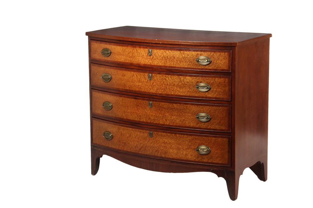 BOWFRONT CHEST OF DRAWERS - Hepplewhite Period,: BOWFRONT CHEST OF DRAWERS - Hepplewhite Period, Portsmouth, NH, in mahogany with bird's-eye maple drawer fascias, the overhanging top having a ribbon inlaid edge, four graduated beaded edge and cross