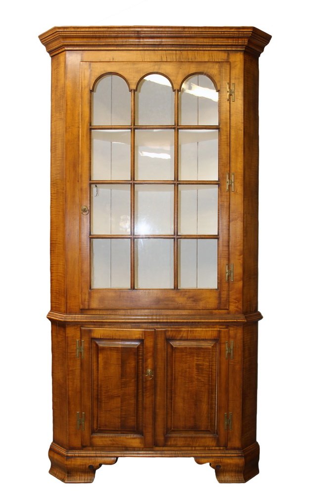 CORNER CABINET - Custom 2-Part Corner Cabinet in tiger: CORNER CABINET - Custom 2-Part Corner Cabinet in tiger maple, having a flat molded cornice, twelve-light rectangular door with arched tops to the three rows, three shaped shelf interior in white paint