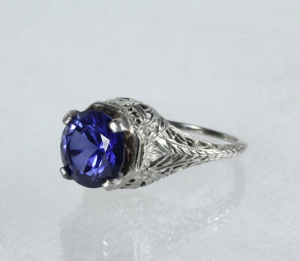 LADY'S RING - 14K White Gold Edwardian Ring set with a: LADY'S RING - 14K White Gold Edwardian Ring set with a synthetic sapphire in a filigree mount, Size 6 1/2, 2.7 dwt tw.