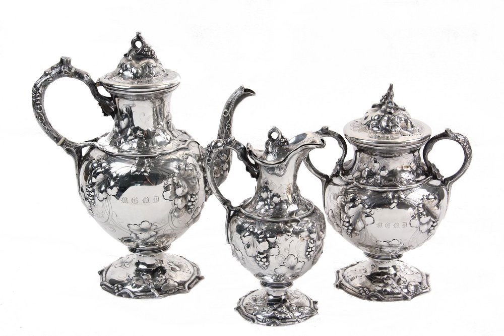 TEA SERVICE - (3)-Piece Coin Silver Tea Service by John: TEA SERVICE - (3)-Piece Coin Silver Tea Service by John C. Moore, New York, retailed by Ball, Tompkins & Black, New York, circa 1850, with ornate repousse and chased grapevine pattern, consisting of t